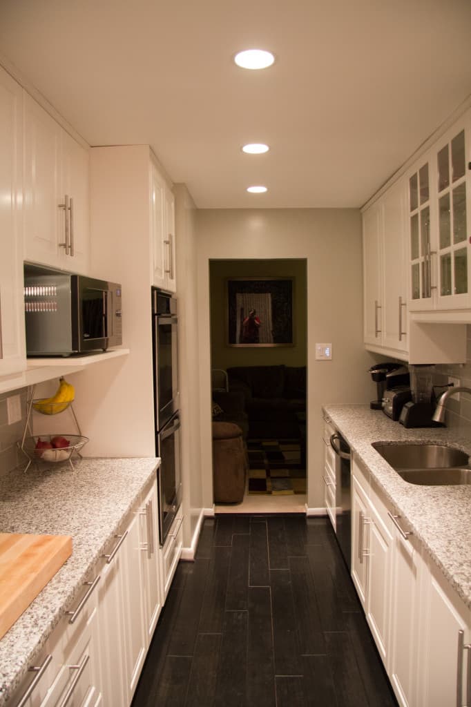 Closer view of the kitchen area, including the double oven and microwave