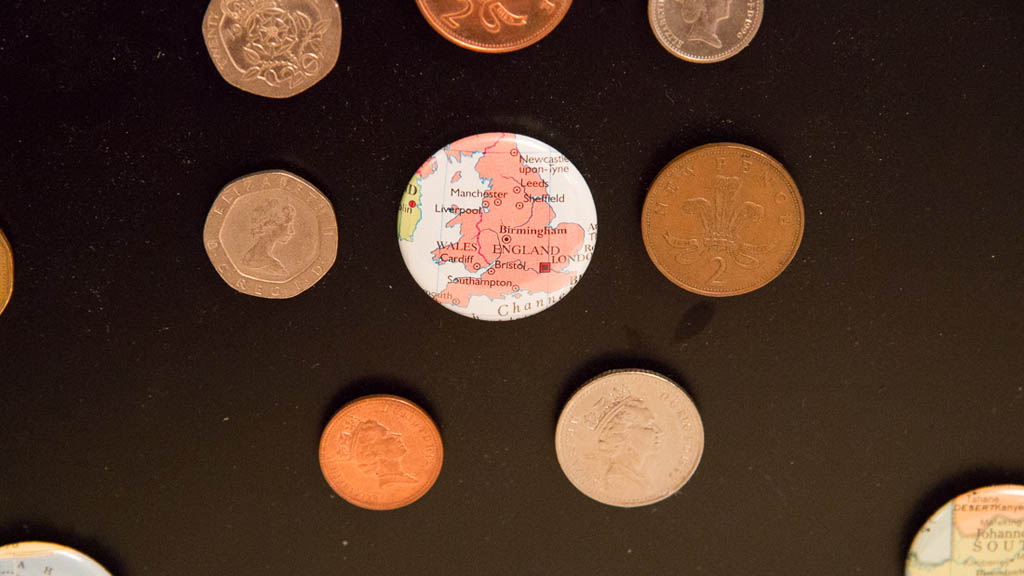 Map magnet of England and a display of British Pound coins