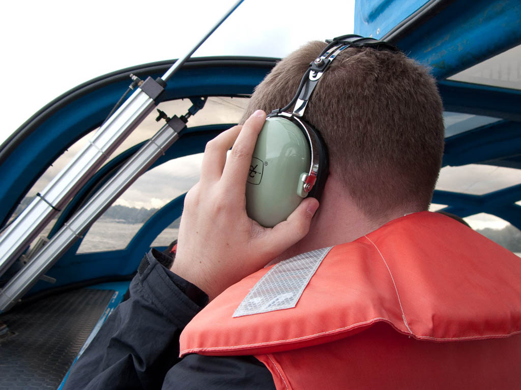 Ken wearing headset on boat tour