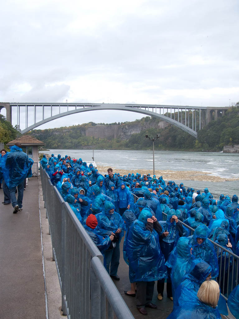 People wearing blue ponchos waiting in line for the Maid of the Mist