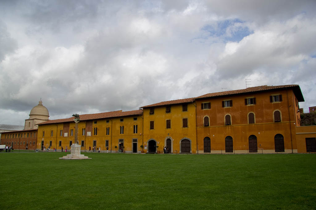 Colorful buildings next to Leaning Tower of Pisa