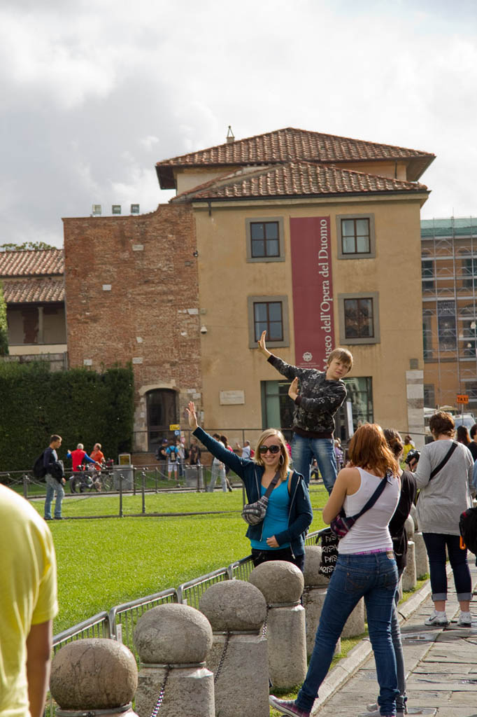 People in pose holding up Leaning Tower of Pisa