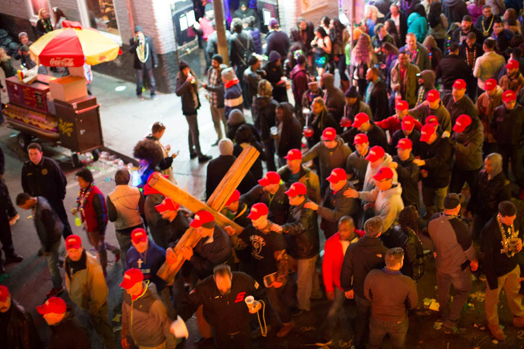 Cross bearing men on Bourbon street during Mardi Gras