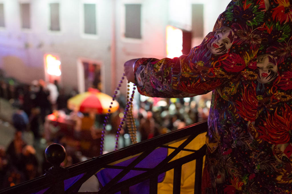 Throwing beads from Bourbon Street Balcony