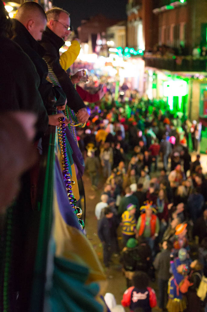 Throwing beads during Mardi Gras