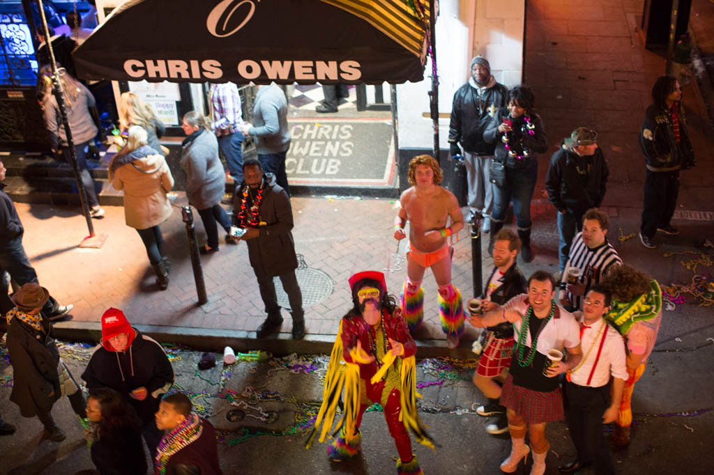 People catching beads thrown from Balcony