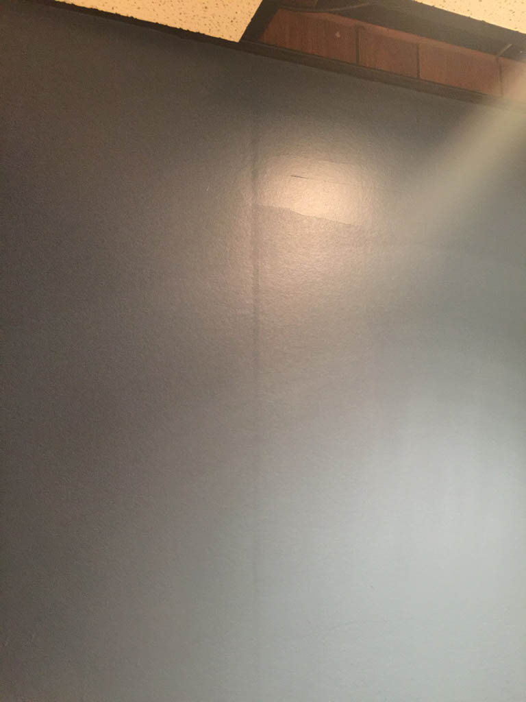 Visible groove in wood paneling under wallpaper